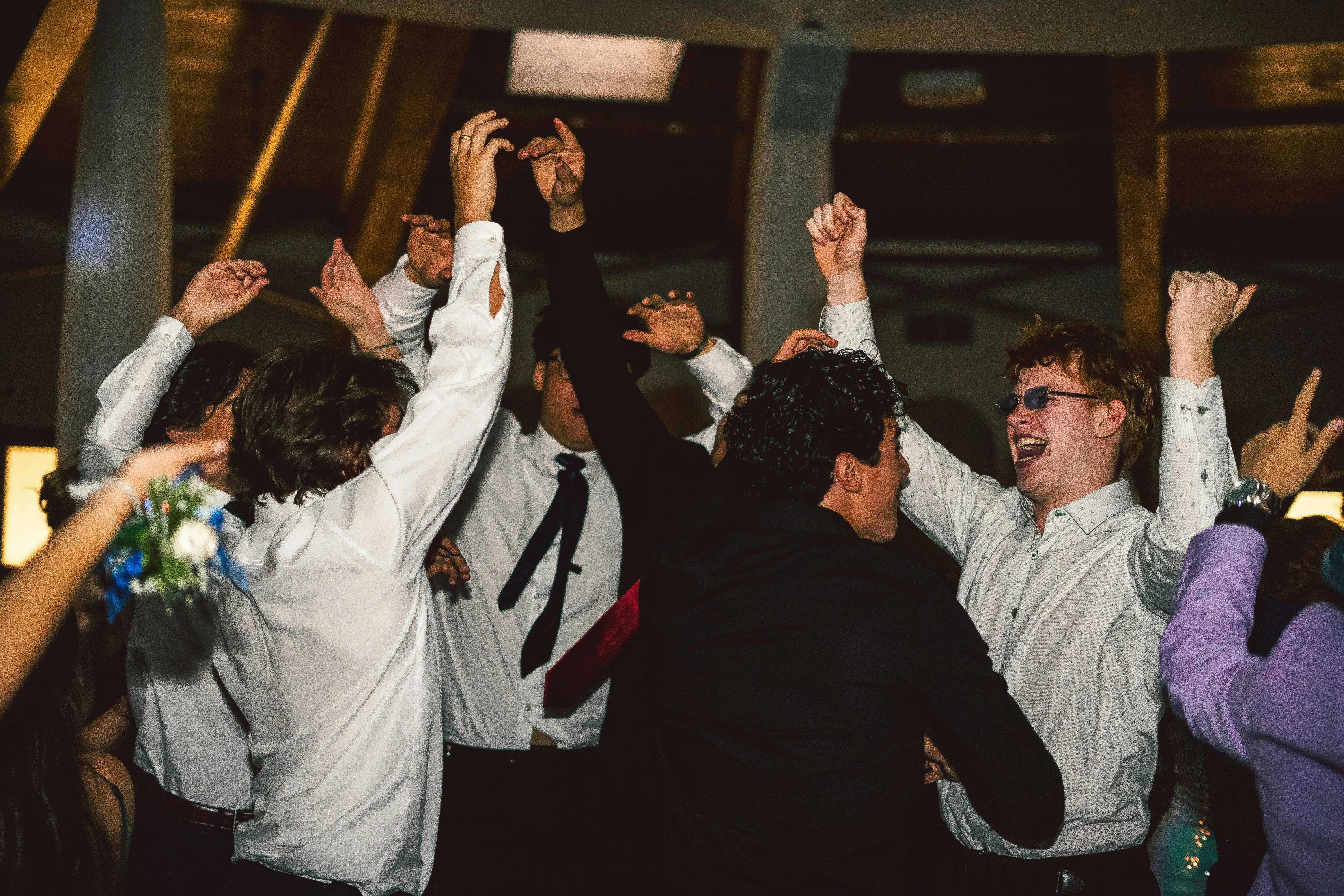 Groep studenten viert samen op Afstudeerfeest met handen omhoog in feestelijke sfeer
