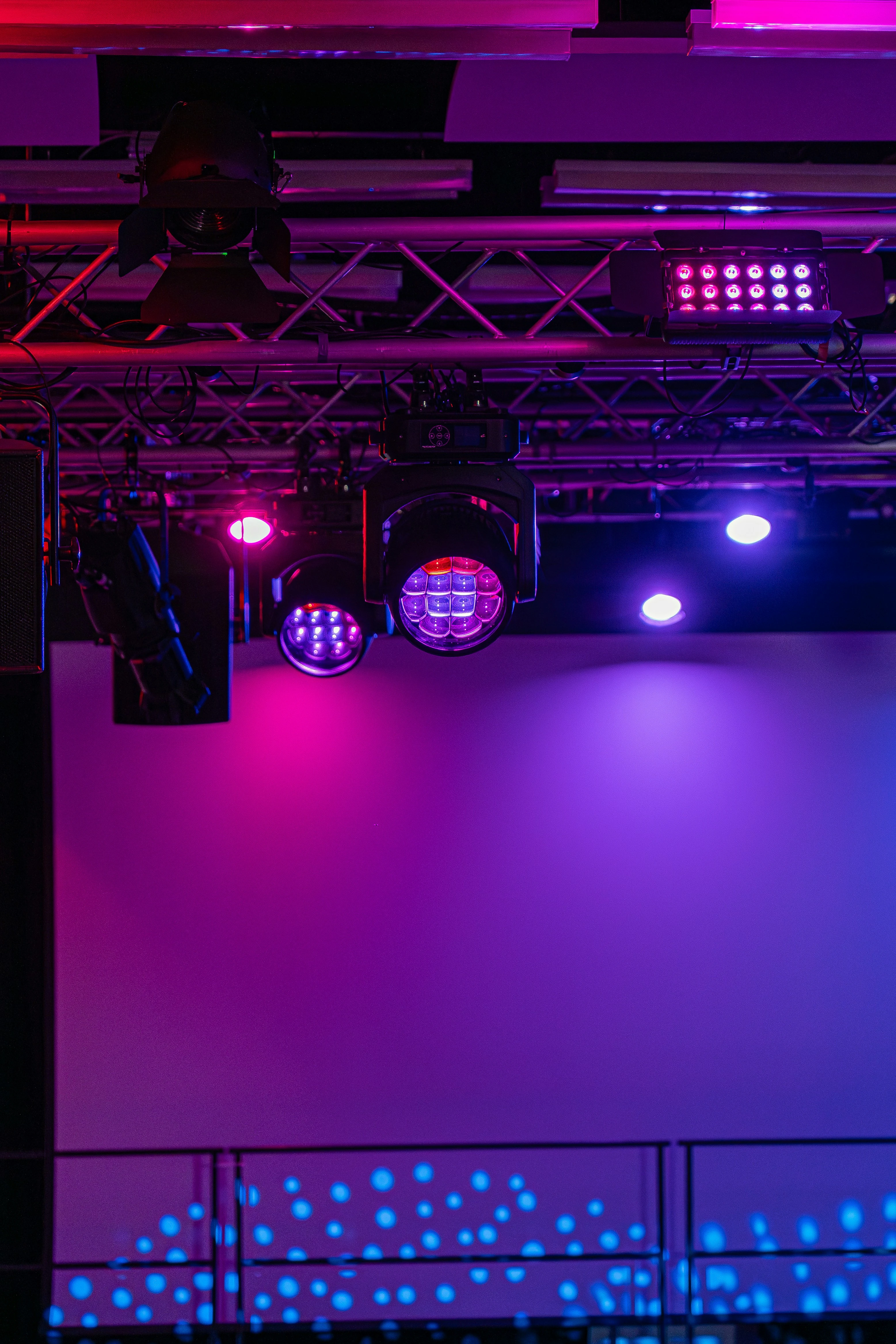 Stage setup at company anniversary with truss structure, moving heads and pink-blue lighting