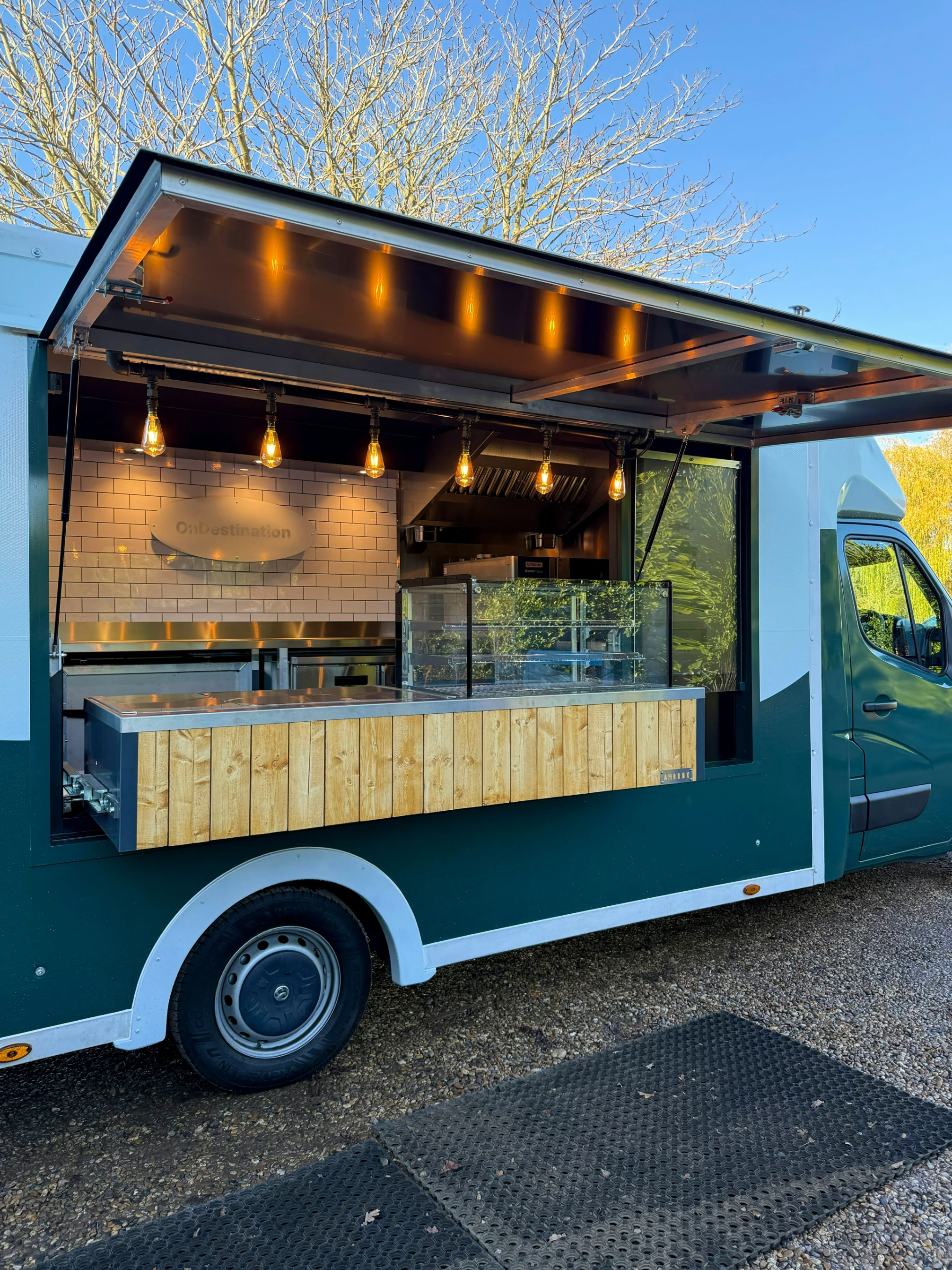 Food truck outside at customer appreciation day with warm lighting and wooden interior